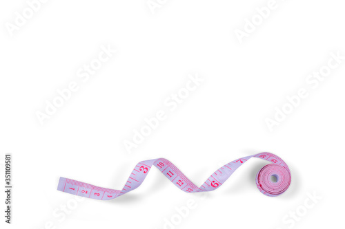 Pink measuring tape isolated on white background. Top view