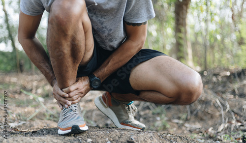 Male runners have experienced pain in the ankle, Injury from workout concept