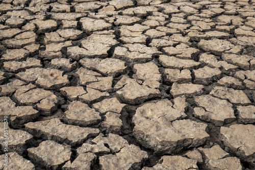 Arid cracked ground. Broken dried mud from arid problem. Global warming crisis.