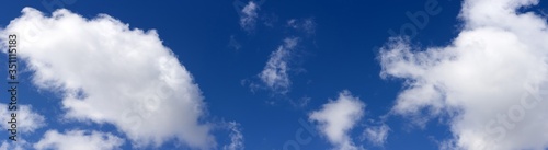 Beautiful clouds on blue sky background, wide panorama of high resolution