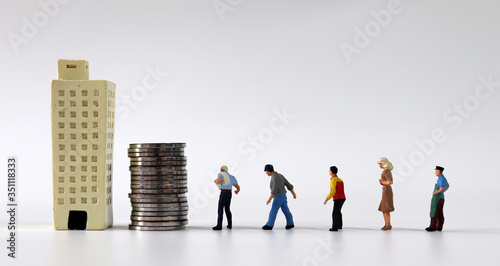 Any of various miniature people lining up beside a pile of coins and a miniature building.
