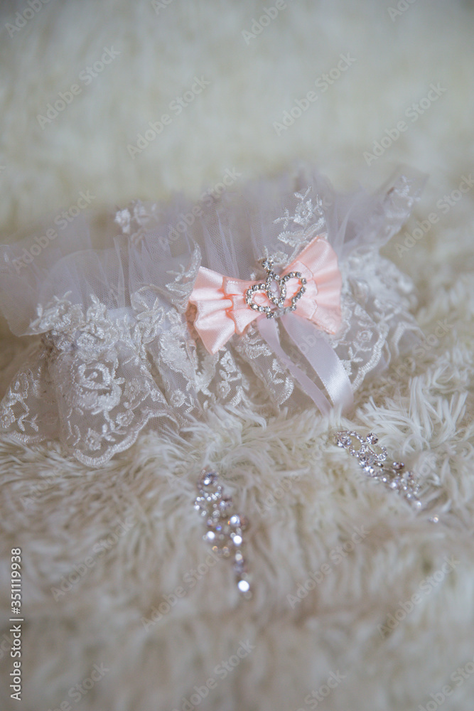 Woman's garter on background. Bride accessories. Stylish blue wedding. Woman's garter on background. Bride accessories. Stylish blue wedding.