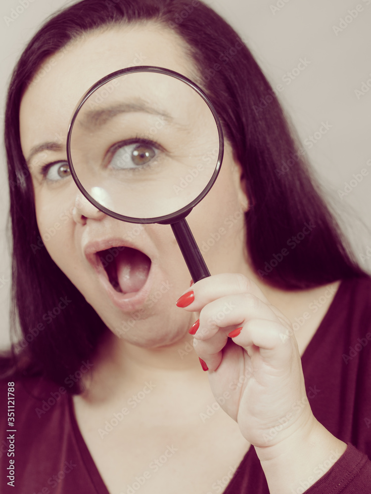 Adult woman with magnifying glss Adult woman with magnifying glss