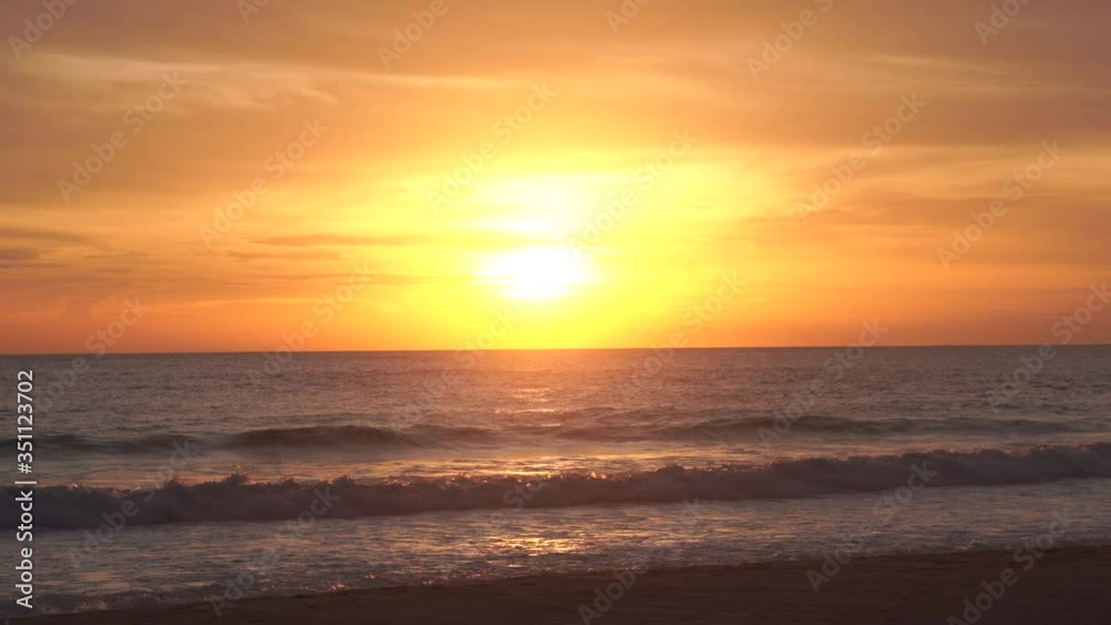 Natural videos and scenery the scene of the waves in the sea moving towards the coast, with the sun falling with gold reflected in the water At the Andaman Sea in Phuket 4K Resolution wide angle shot. Natural videos and scenery the scene of the waves in the sea moving towards the coast, with the sun falling with gold reflected in the water At the Andaman Sea in Phuket 4K Resolution wide angle shot.