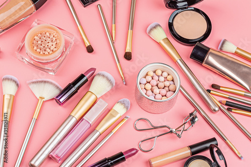 Cosmetic products on pink background. Flat lay, top view.