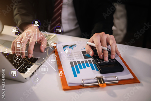 Male businessman working on desk office with using a calculator to calculate the numbers, finance accounting concept.