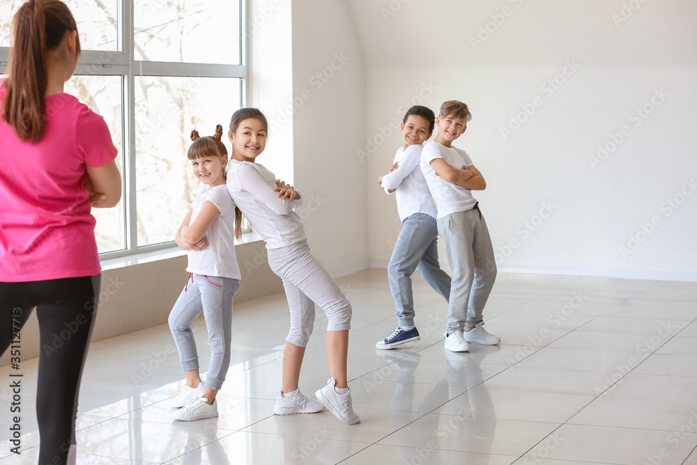 Fototapeta premium Cute little children with teacher in dance studio
