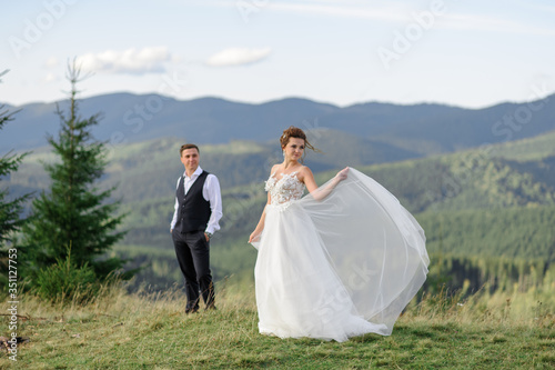 Newlyweds celebrate their wedding in the mountains.