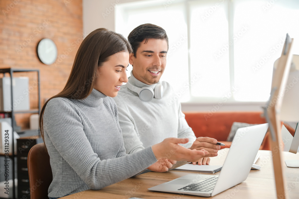 Young couple working together at home