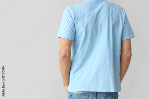 Man in stylish t-shirt on grey background