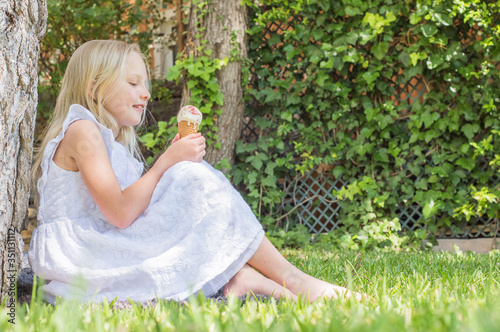 Portrait of a cute girl with ice cream. Summertime fun.