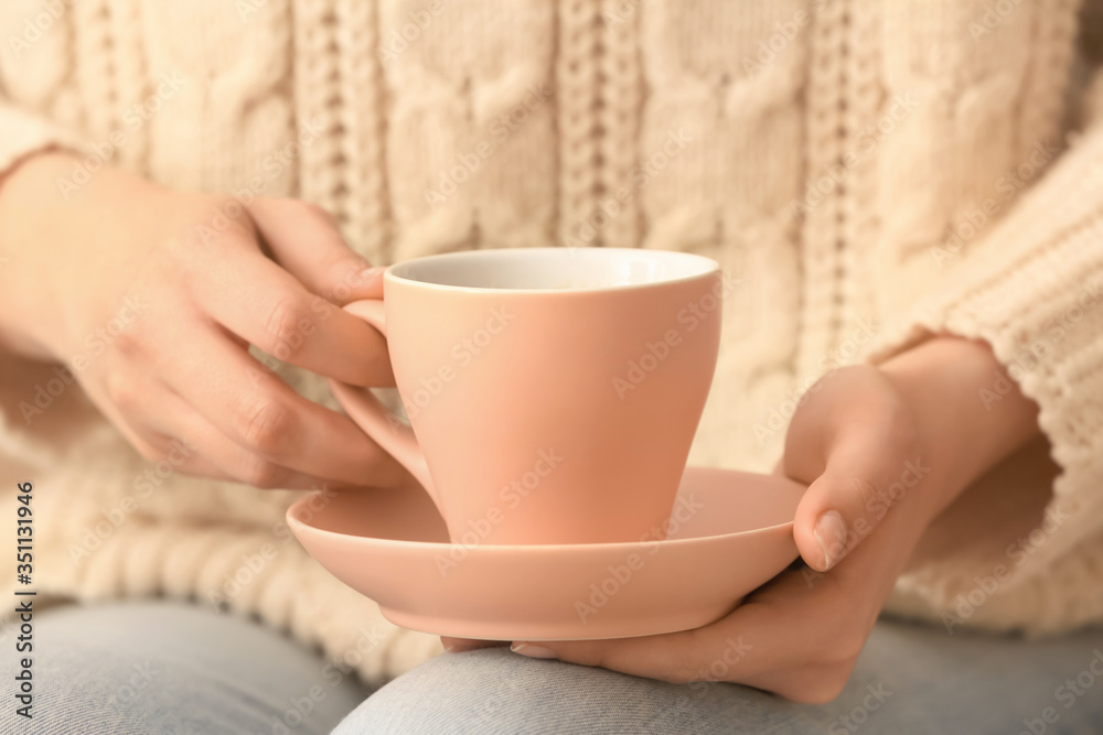 Woman with cup of tea, closeup