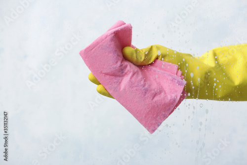Housewife cleaning window a...