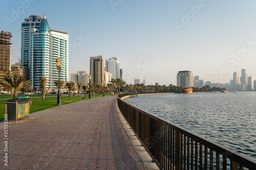 A large and beautiful promenade by the sea with palm trees in the evening in the UAE   UNITED ARAB EMIRATES, SHARJAH - 17 OCTOBER 2017. © Руслан Секачев