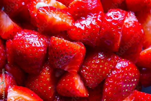 evocative close-up of washed and cut strawberries
