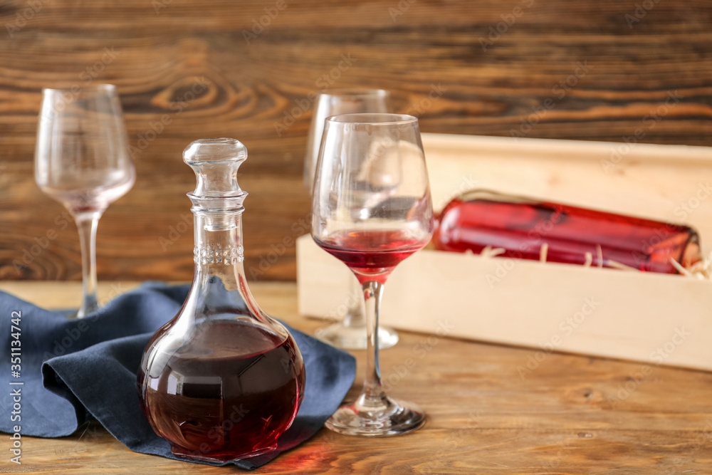 Decanter of wine with glasses on wooden background Decanter of wine with glasses on wooden background