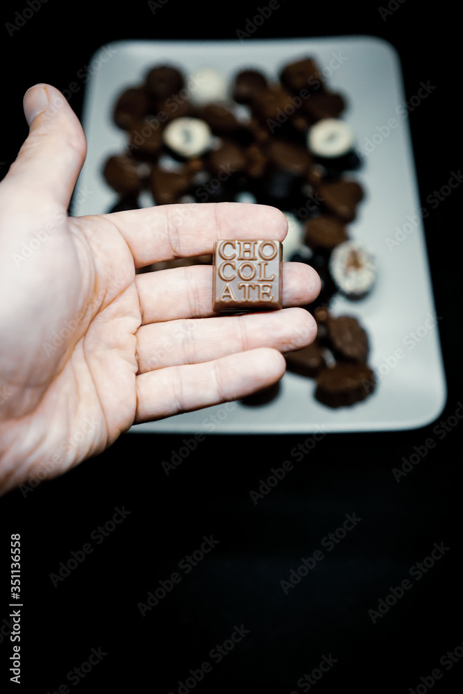 Fototapeta premium man holding a square chocolate.