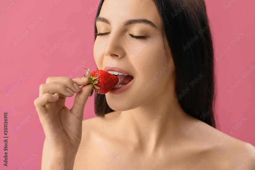 Sexy young woman with strawberry on color background Sexy young woman with strawberry on color background