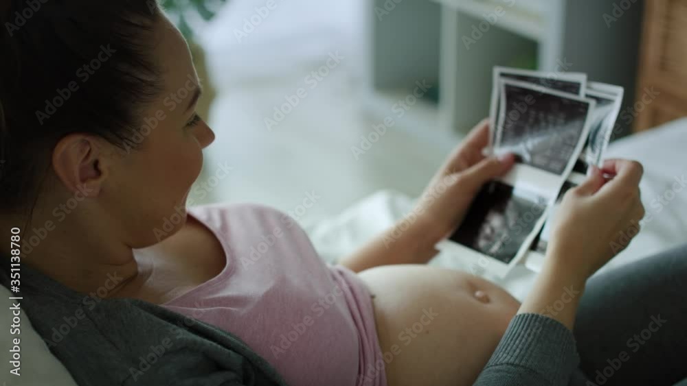 Tracking right video of pregnant woman browsing ultrasound images. Shot with RED helium camera in 8K 