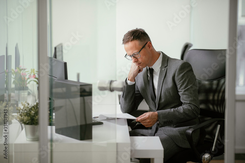 Handsome businessman working in office. Young man preparing for the meeting.