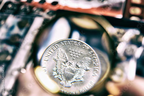 American silver dollar with magnifying glass