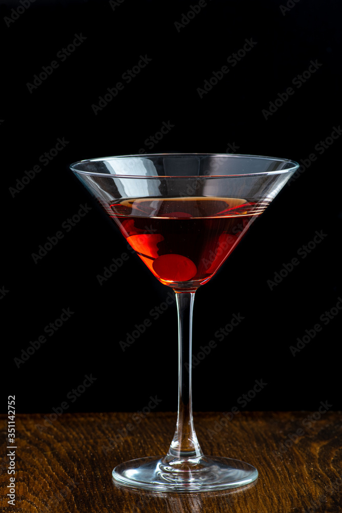 manhattan cocktail in martini glass on dark background