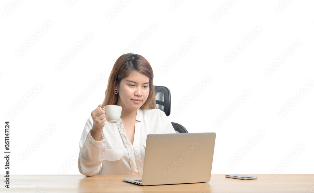 young woman working on laptop computer while sitting at the living room, drinking coffee young woman working on laptop computer while sitting at the living room, drinking coffee