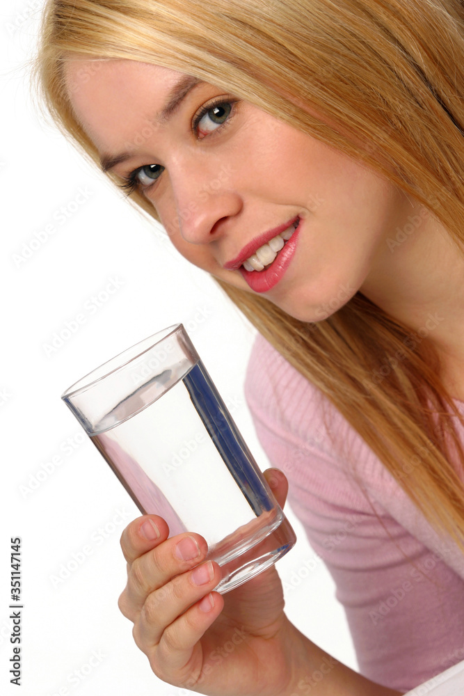 A woman holding a glass of water A woman holding a glass of water