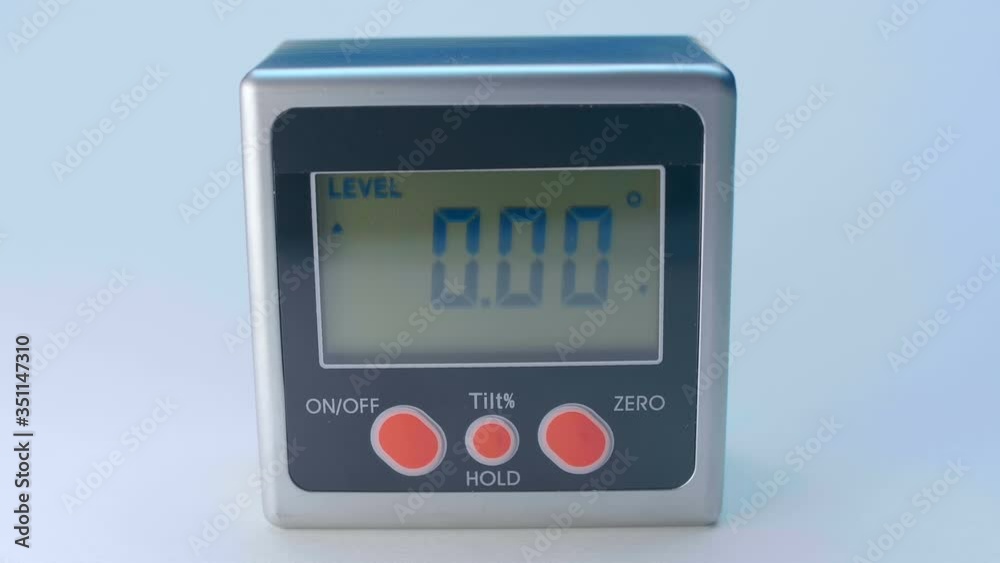 The modern device, which is very necessary in construction and repair - digital magnetic goniometer - measuring the angle of an inclined surface. Macro. Closeup The modern device, which is very necessary in construction and repair - digital magnetic goniometer - measuring the angle of an inclined surface. Macro. Closeup