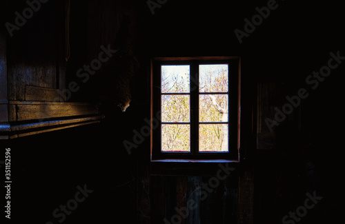Dark room with sunlit windows as an abstract background.