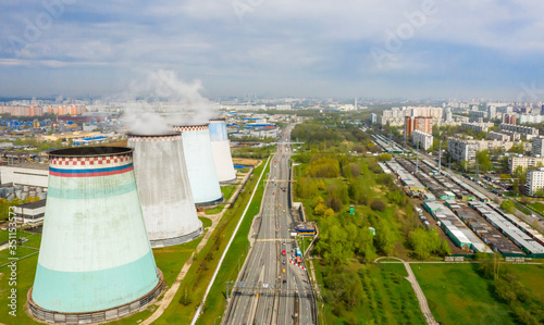 power plant pipes and cooling towers on the background of the panorama of the Moscow city against blue sky. Biryulyovo district in the south of Moscow photo