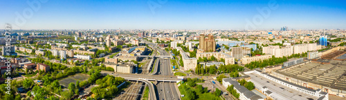 Aerial top view of road junction in Moscow from above, automobile traffic and the old Ugreshskaya railway station in the Moscow industrial zone near the automobile ring highway