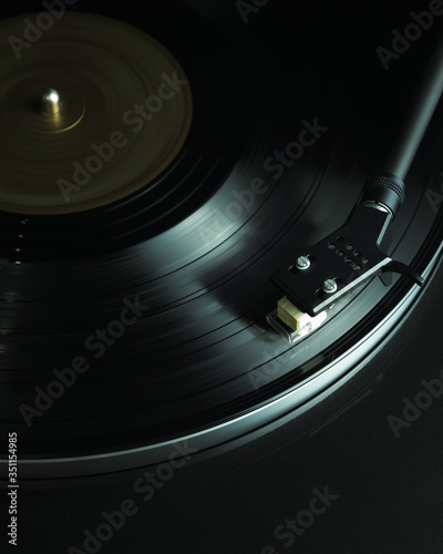 Close up turntable and vinyl disc in motion