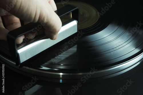 hand holding leaning brush for vinyl disc