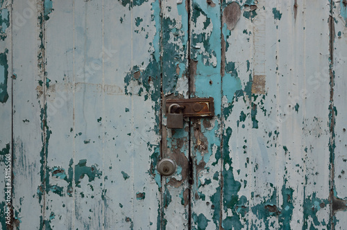 Rusted keys to lock vintage old green wood door