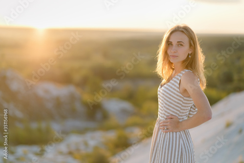 Portrait of a red-haired girl at a sunset