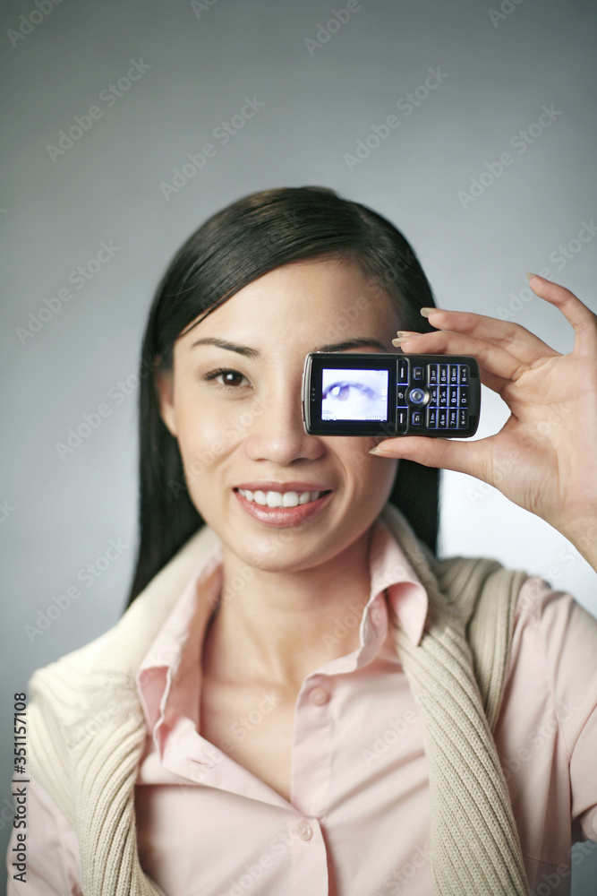 Businesswoman taking picture with her camera phone Businesswoman taking picture with her camera phone
