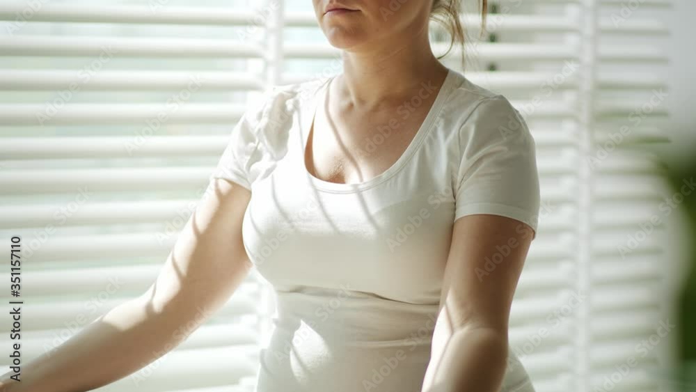 Handheld video of pregnant woman meditation in the sunbeams. Shot with RED helium camera in 8K Handheld video of pregnant woman meditation in the sunbeams. Shot with RED helium camera in 8K