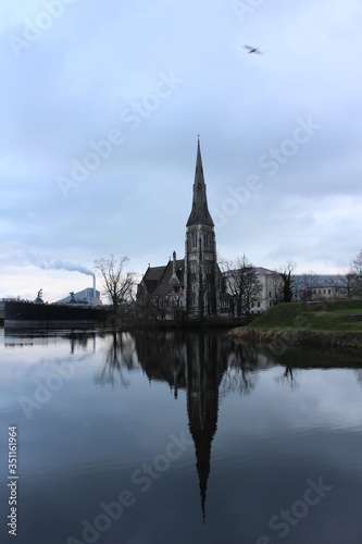 Castle in Copenhagen, Denmark reflecting off a canal water during a cloud day in February