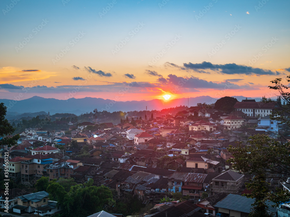 Aerial view of Phongsali, North Laos near China. Yunnan style town on scenic mountain ridge. Travel destination for tribal trekking in Akha villages. Sunset light
