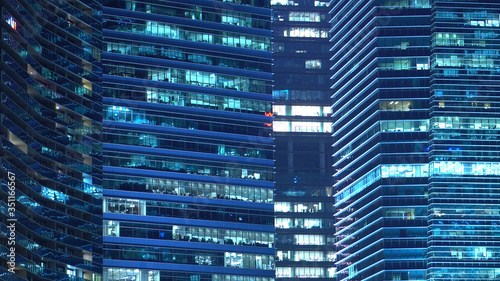 Contemporary Modern Glass Windows of Office Buildings at Night 