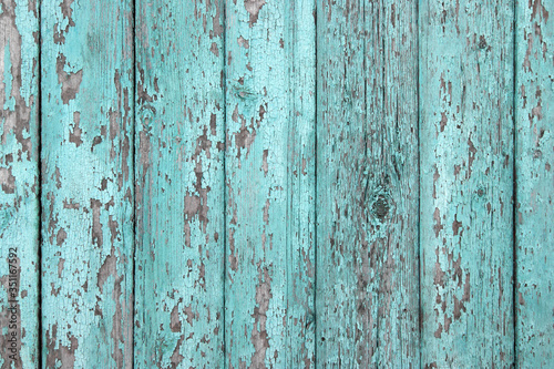 Crackled paint on old light blue wood planks. © iama_sing