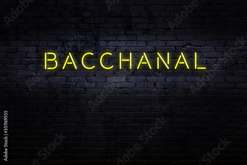Obraz na plátně Night view of neon sign on brick wall with inscription bacchanal