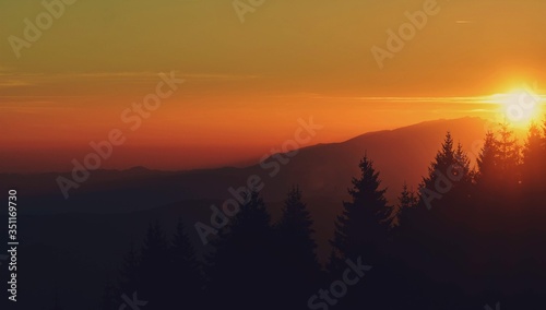 beautiful sunset with colorfully clouds at the mountain. horizon seen from high altitude © badescu