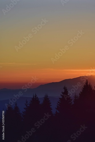 beautiful sunset with colorfully clouds at the mountain. horizon seen from high altitude © badescu