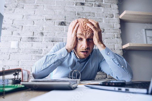 Obraz na plátně Crying businessman stressed about bankruptcy debt.