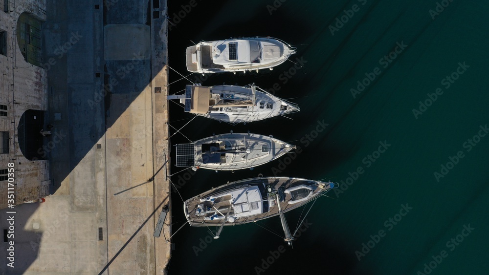 Aerial top down view of sailing boats moored in harbour Senglea (Isla), Bormla, Malta - island with old medieval architecture and culture. Water transport, nautical vessel.
Aerial top down view of sailing boats moored in harbour Senglea (Isla), Bormla, Malta - island with old medieval architecture and culture. Water transport, nautical vessel.