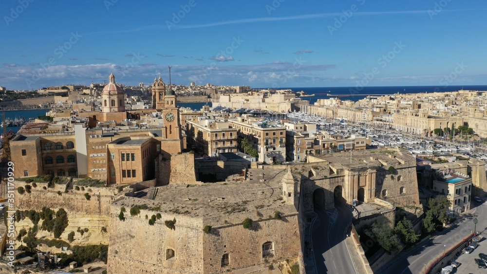 Aerial view of Senglea, Bormla, Valletta old architecture, ancient churches, fortress, cathedrals, bell towers, harbour with sailing boats. Malta. Travel destination. Summer sunny day.
