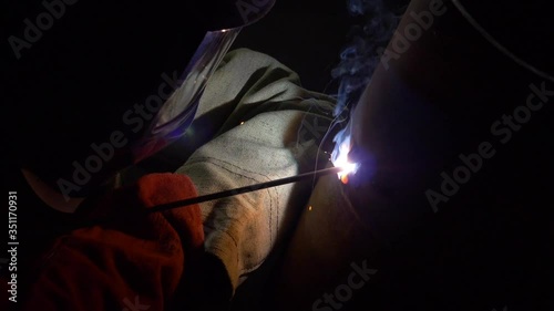 Industrial Worker, welder takes off and puts on a mask, smoking a metal pipe, Slow motion Footage
