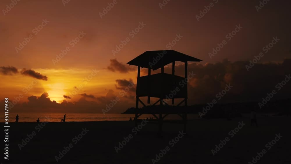 Sunset in the beach with the lifeguard tower . Sunset in the beach with the lifeguard tower .